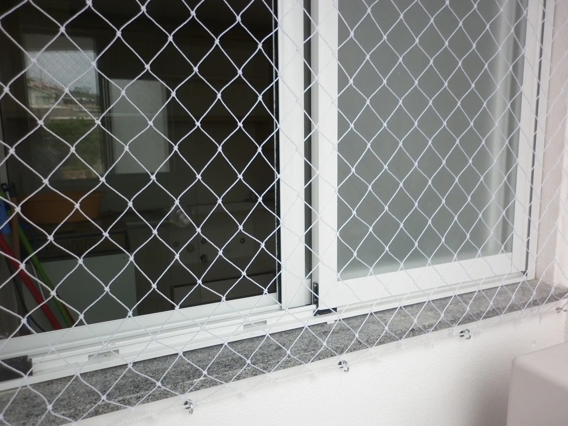 Janela com rede de proteção conforme NBR 16046